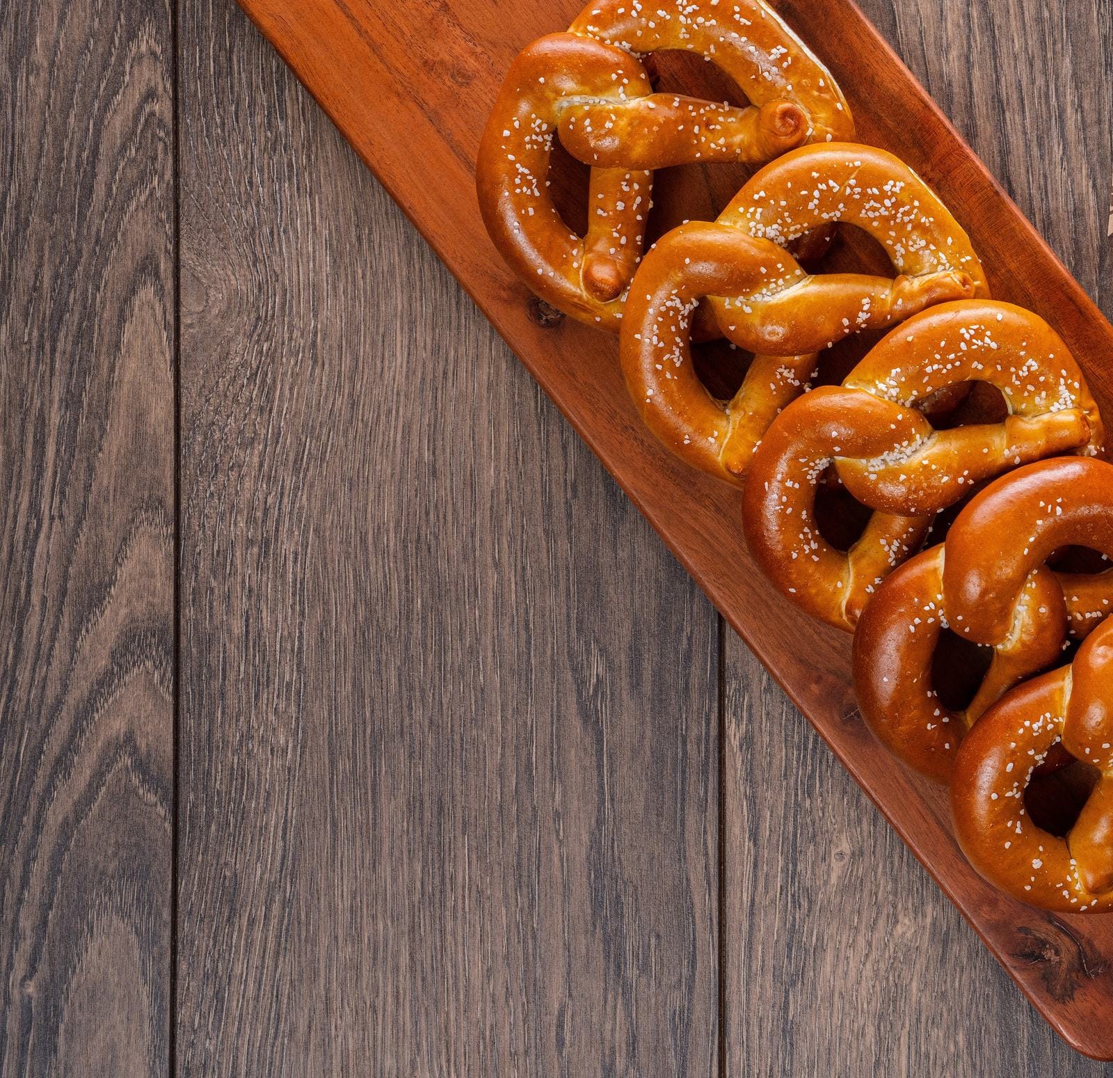 Bavarian-style soft pretzels on a wooden serving board