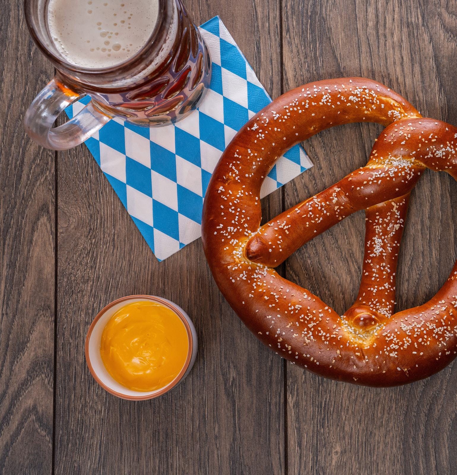 A Bavarian-style soft pretzel served with beer and mustard